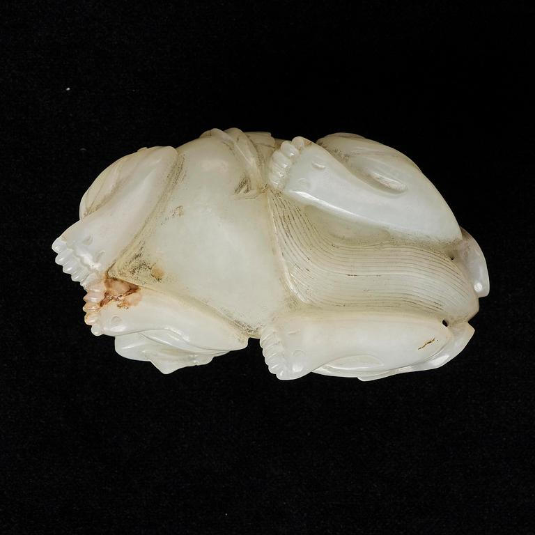 A Chinese nephrite carving of a recumbant lion with her cub, Qing dynasty.