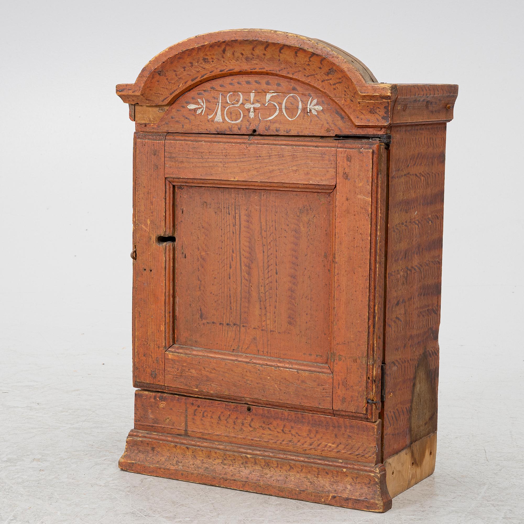 A hanging cabinet, dated 1850.