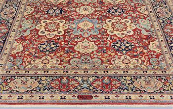A Sarouk carpet, signed, approx. 327 x 253 cm.