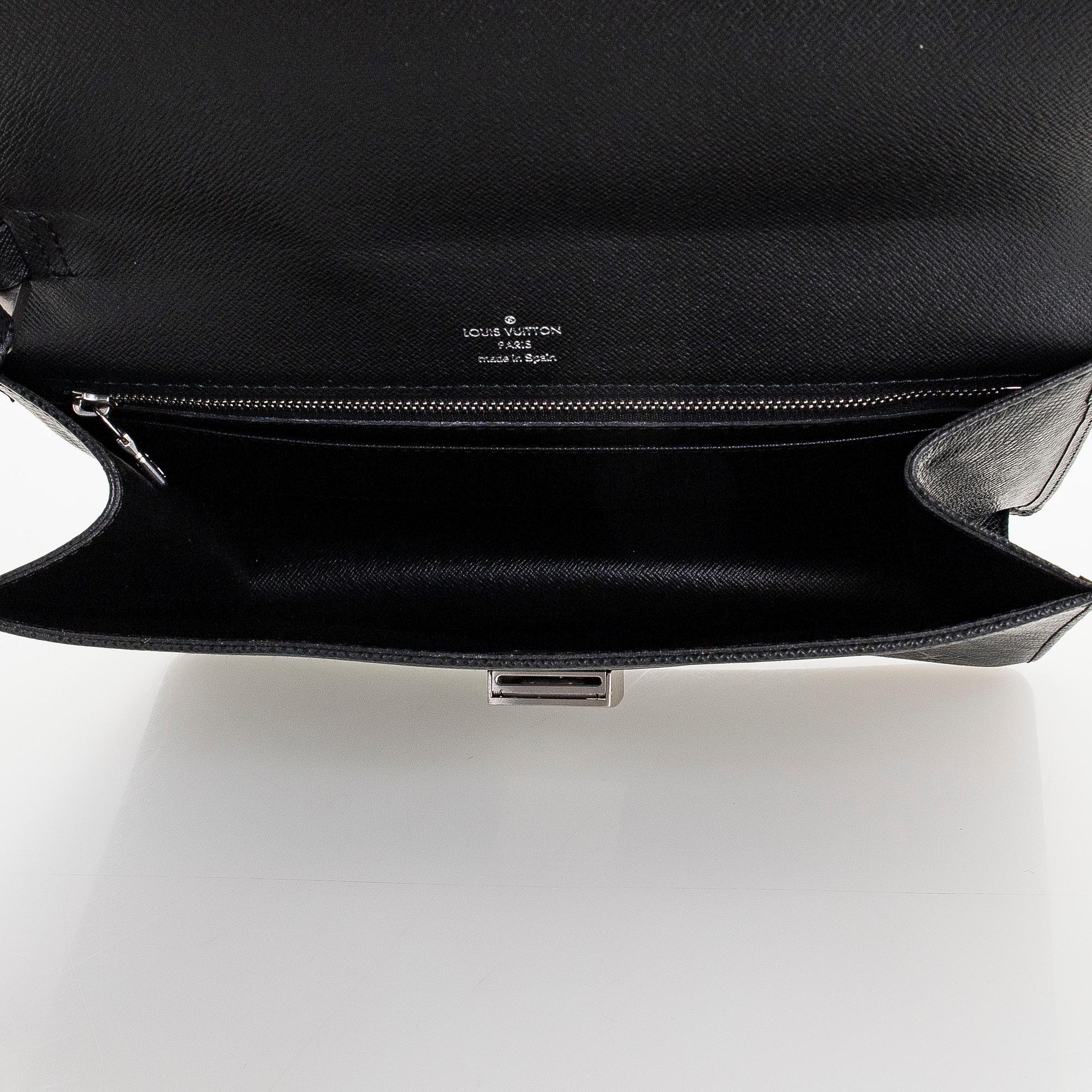 Louis Vuitton, a 'Selenga' clutch bag.