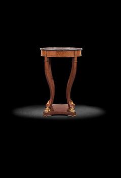 A Swedish 1830/40's porphyry table top. Later Empire-style mahogany veneer stand.