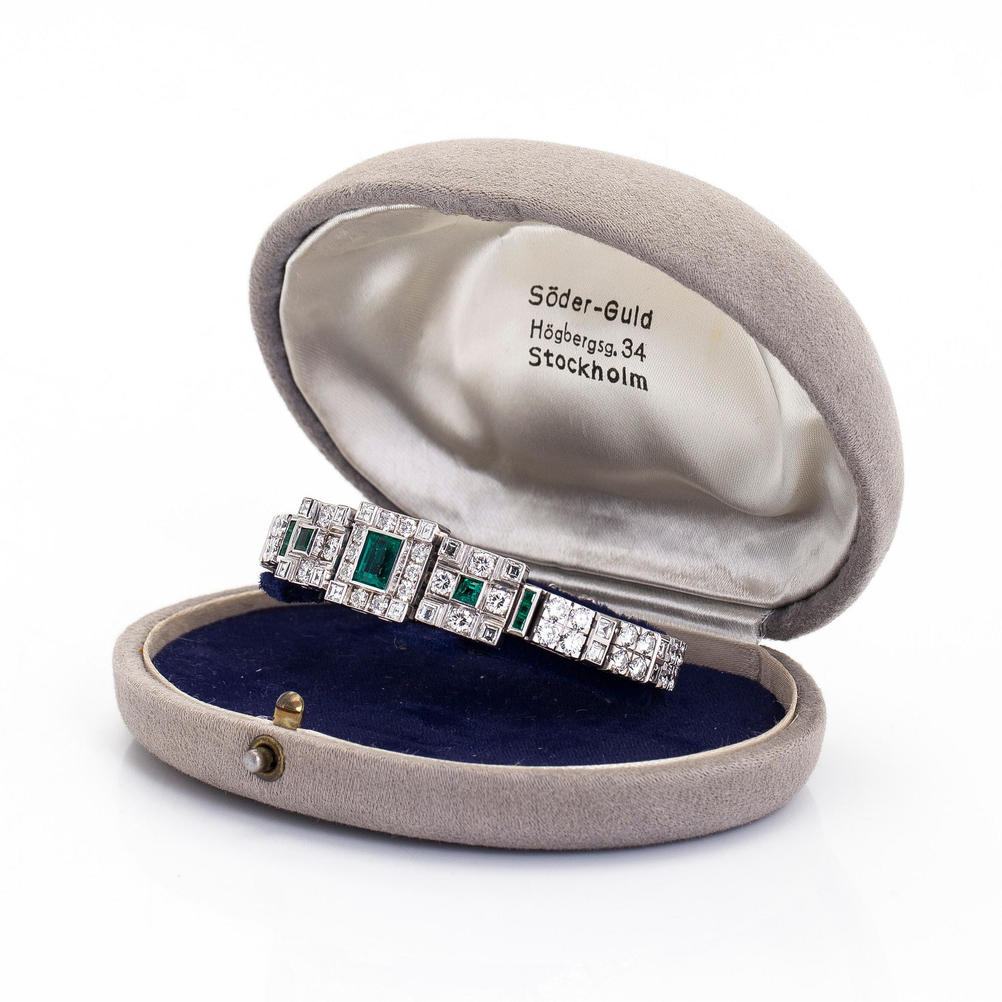 Rannekoru, 18K valkokultaa, smaragdeja sekä briljantti- ja baguettehiottuja timantteja, Tukholma 1986.