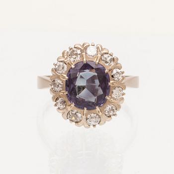 An 18K white gold ring with a colour change synthetic purple sapphire and brilliant and old cut diamonds.