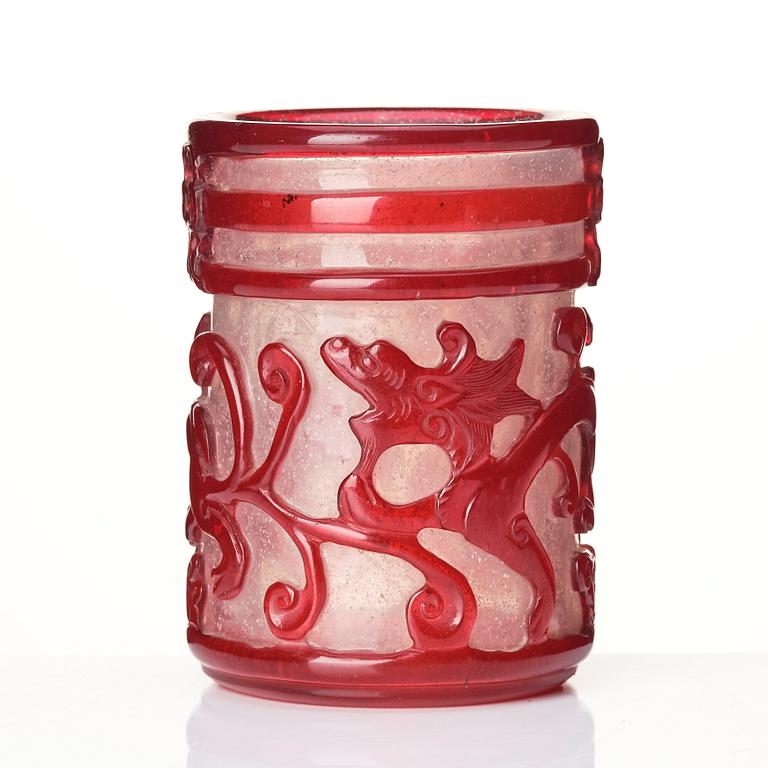 A ruby red overlay Beijing glass 'chilong' brush pot, with a seal mark.