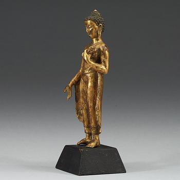 A standing gilt bronze figure of Buddha, Nepal, 19th Century.