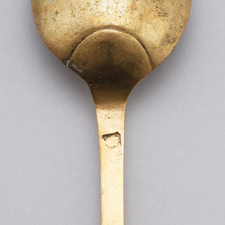 A brass (originally silver plated) spoon by Erik Castman.