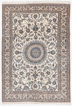 An Oriental carpet, approx. 354 x 243 cm.