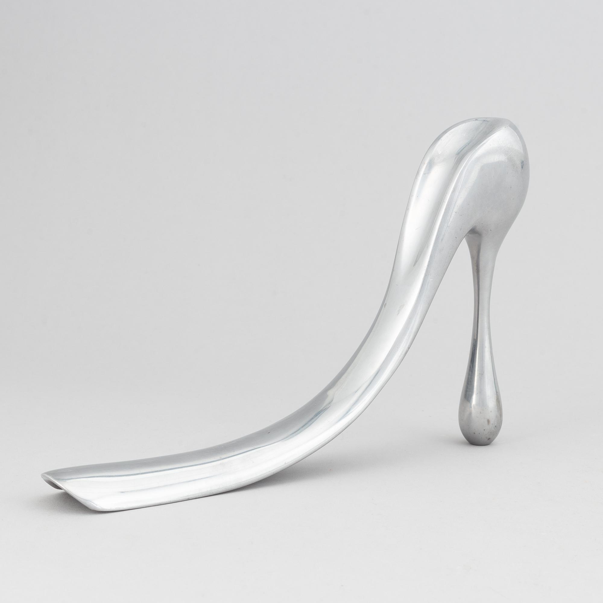 Manolo Blahnik, a metal shoe horn, 21st century.