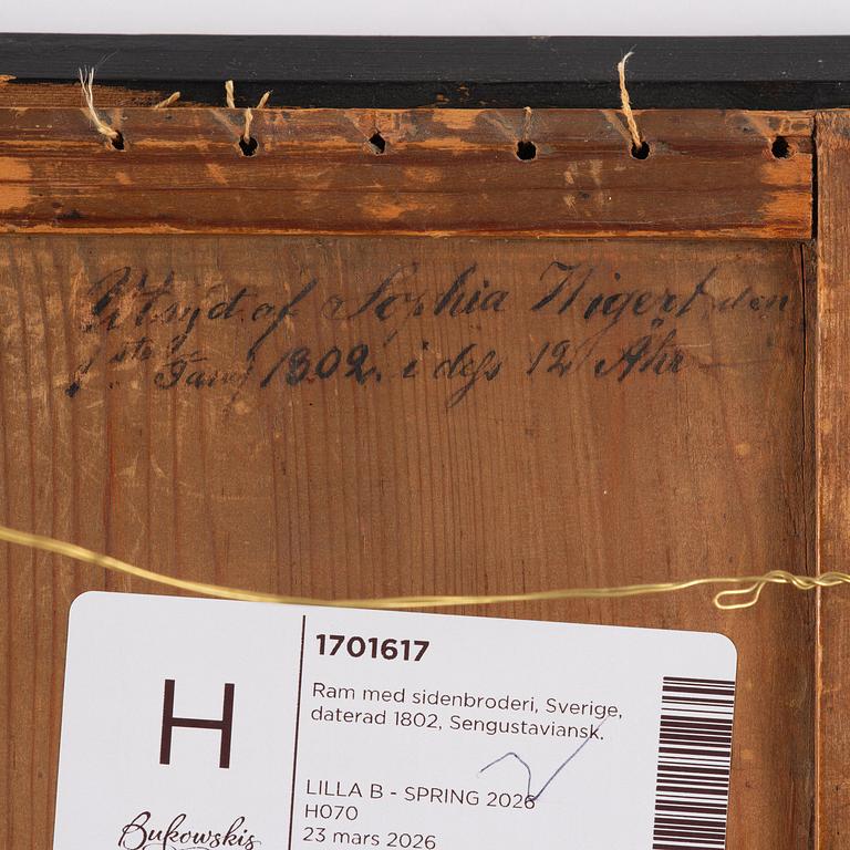 A late Gustavian frame and silk embroidery, dated 1802.