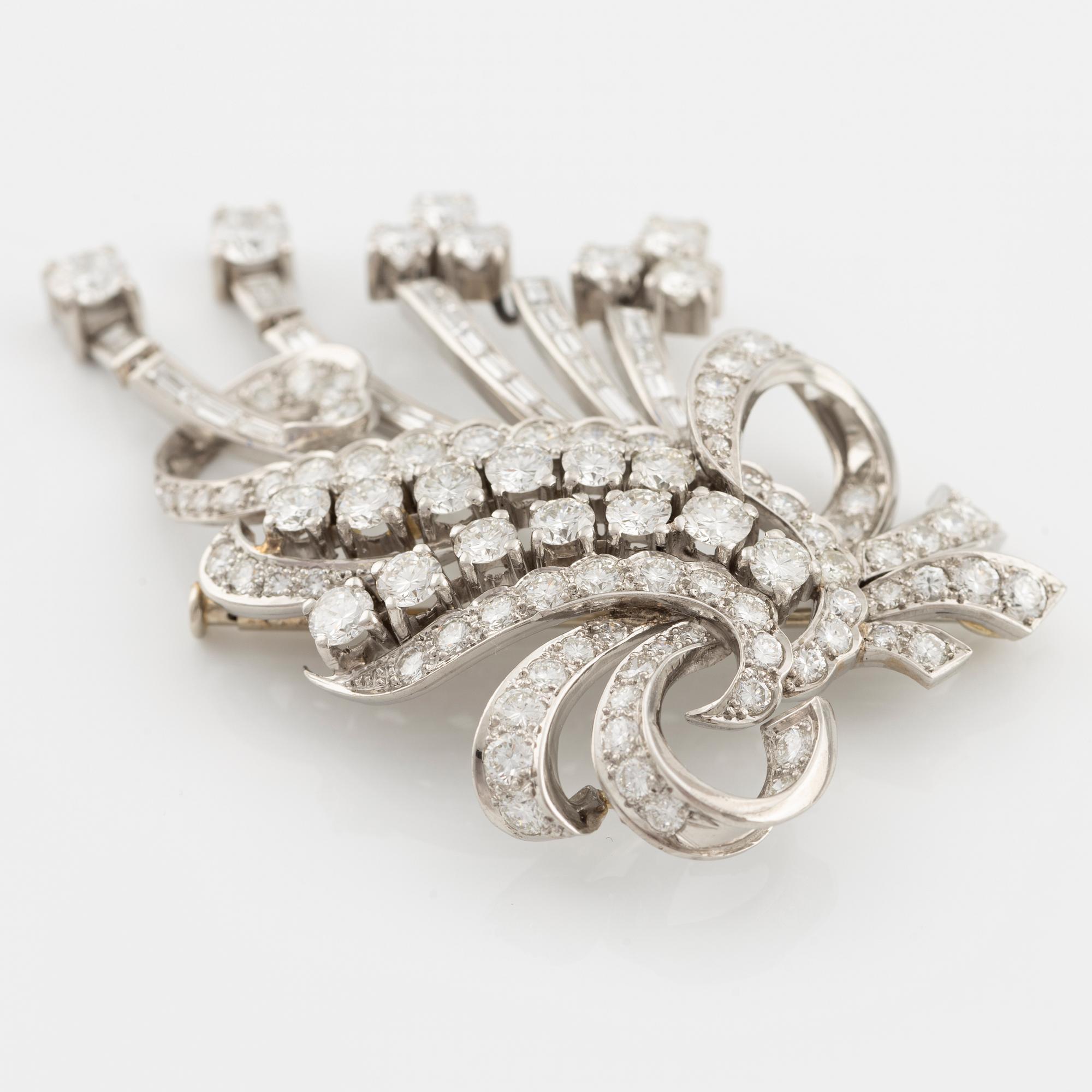 A platinum brooch with round brilliant and baguette-cut diamonds.