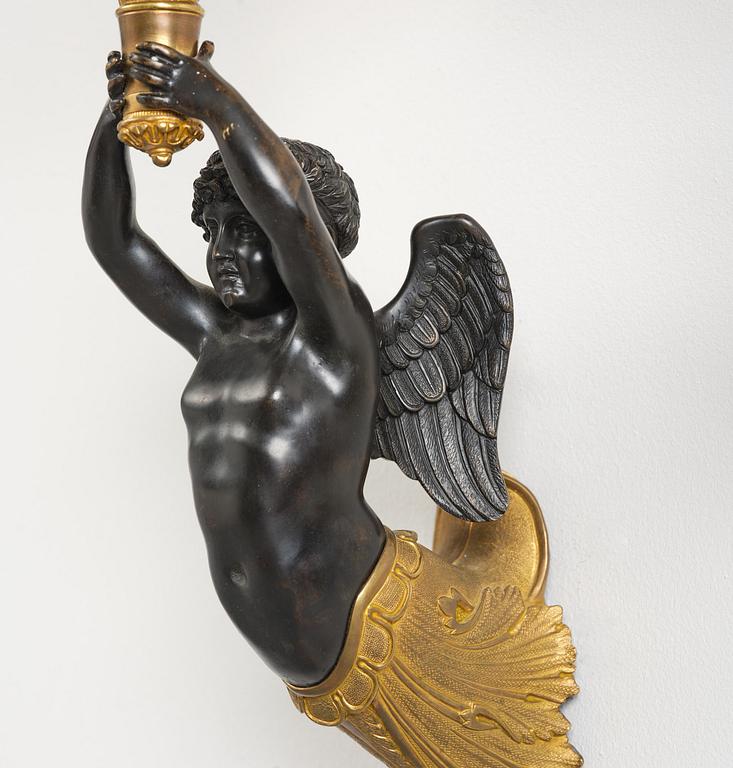 A pair of Napoleon III five-branch gilt and patinated bronze appliques.