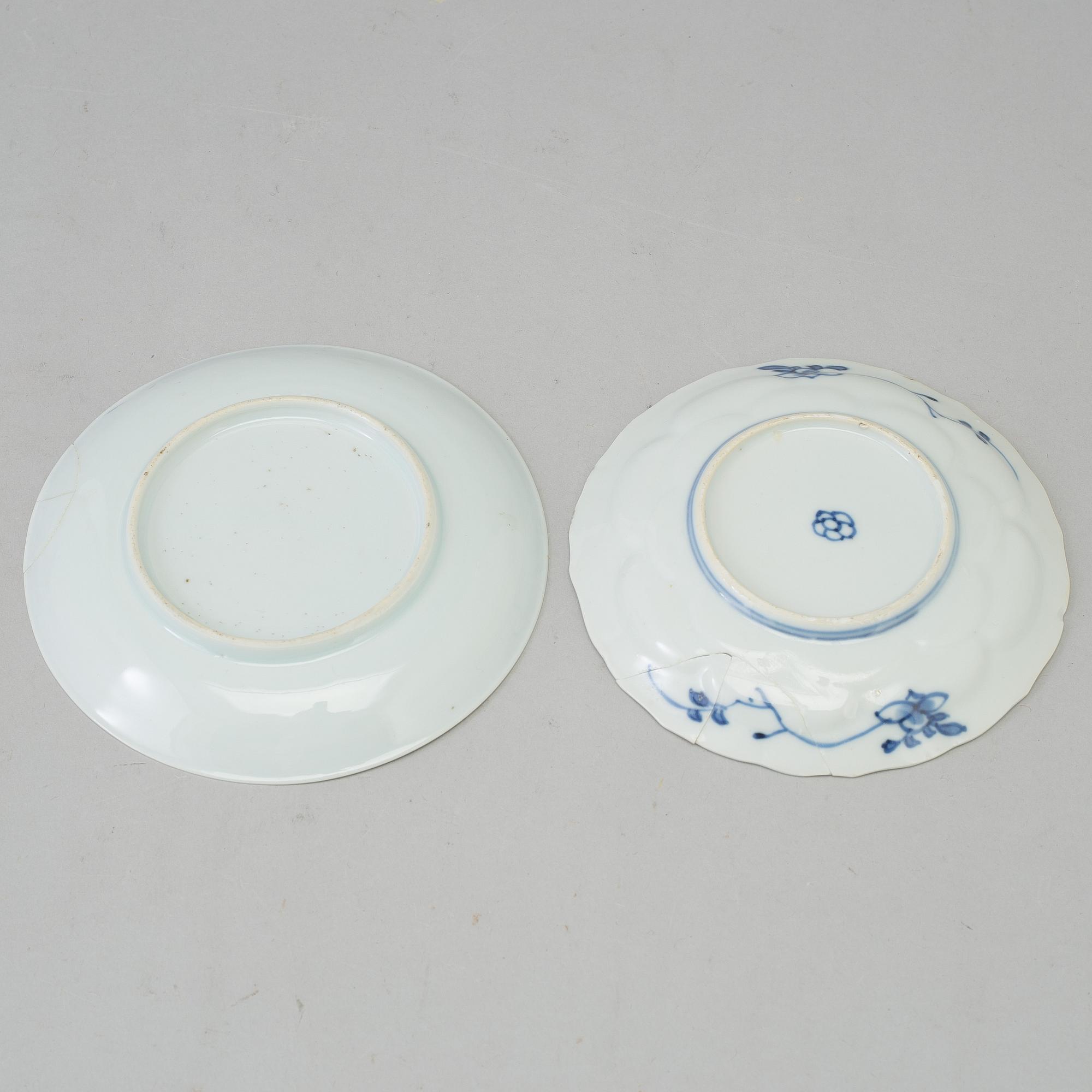 Two blue and white dishes and two cups with dishes, Qing dynasty, Qianlong (1736-95) and Kangxi (1662-1722).