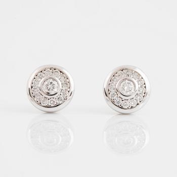 A pair of 14K gold earrings set with round brilliant-cut diamonds.