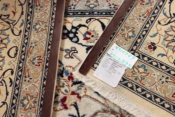A Nain carpet, part silk, 9 laa, c. 390 x 295 cm.