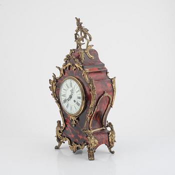 A Louis XV-style 'faux tortoise' and gilt brass-mounted striking mantel clock, late 19th century.