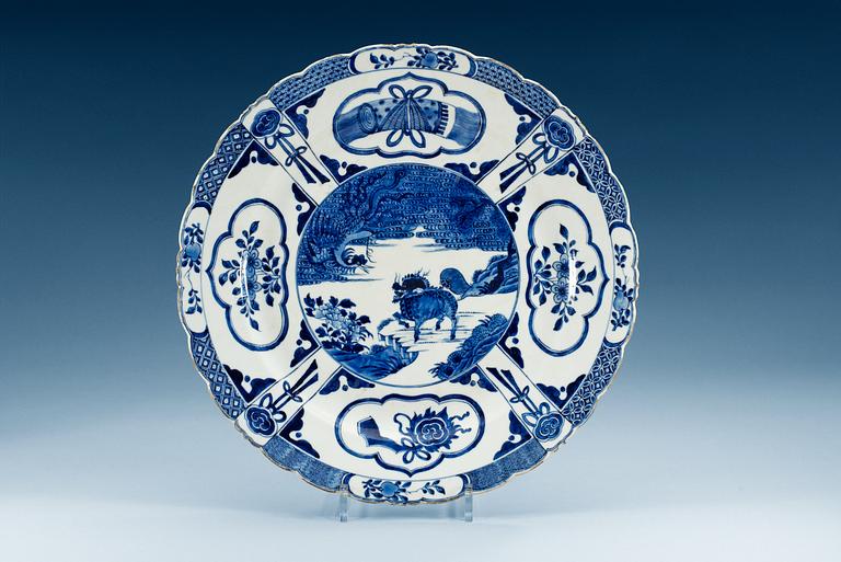 A blue and  white charger decorated with a Qilin and phoenix, Qing dynasty, Kangxi (1662-1722).