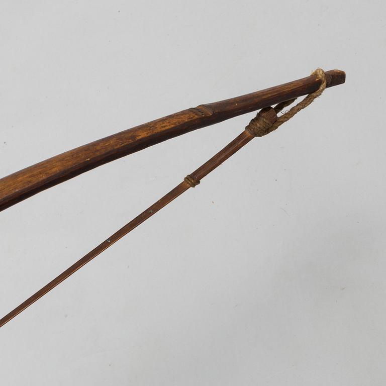 A 19th/20th century south-east asian bow with an arrow.