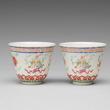 A pair of Chinese famille rose ba jixiang wine cups, Republic, with Guangxu six character mark.