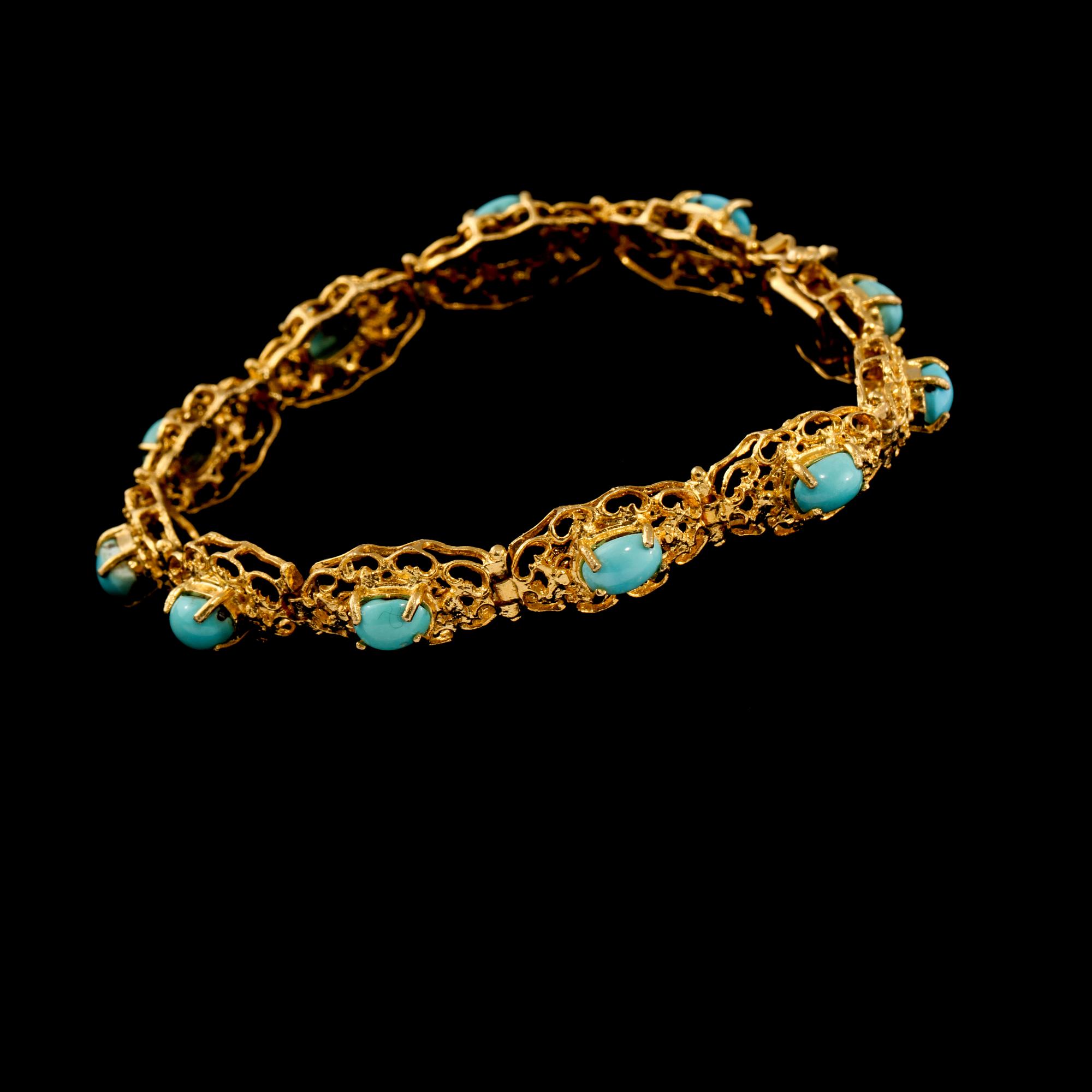 ARMLÄNK, 18k guld med 11 cabochonslipade turkoser, utländska stämplar. Vikt 20 g.