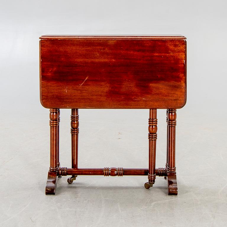 A 20th century English mahogany folding table.