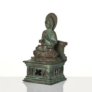 A bronze Buddha Vairocana, Eastern Java, 10th century.