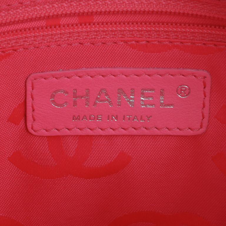 CHANEL, a black leather quilted pochette with short shoulder strap.