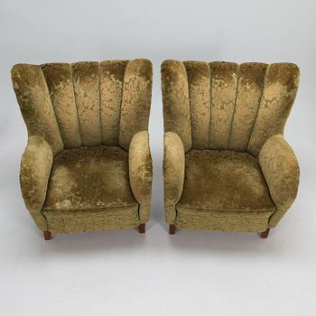 A pair of mid-20th-century armchairs.