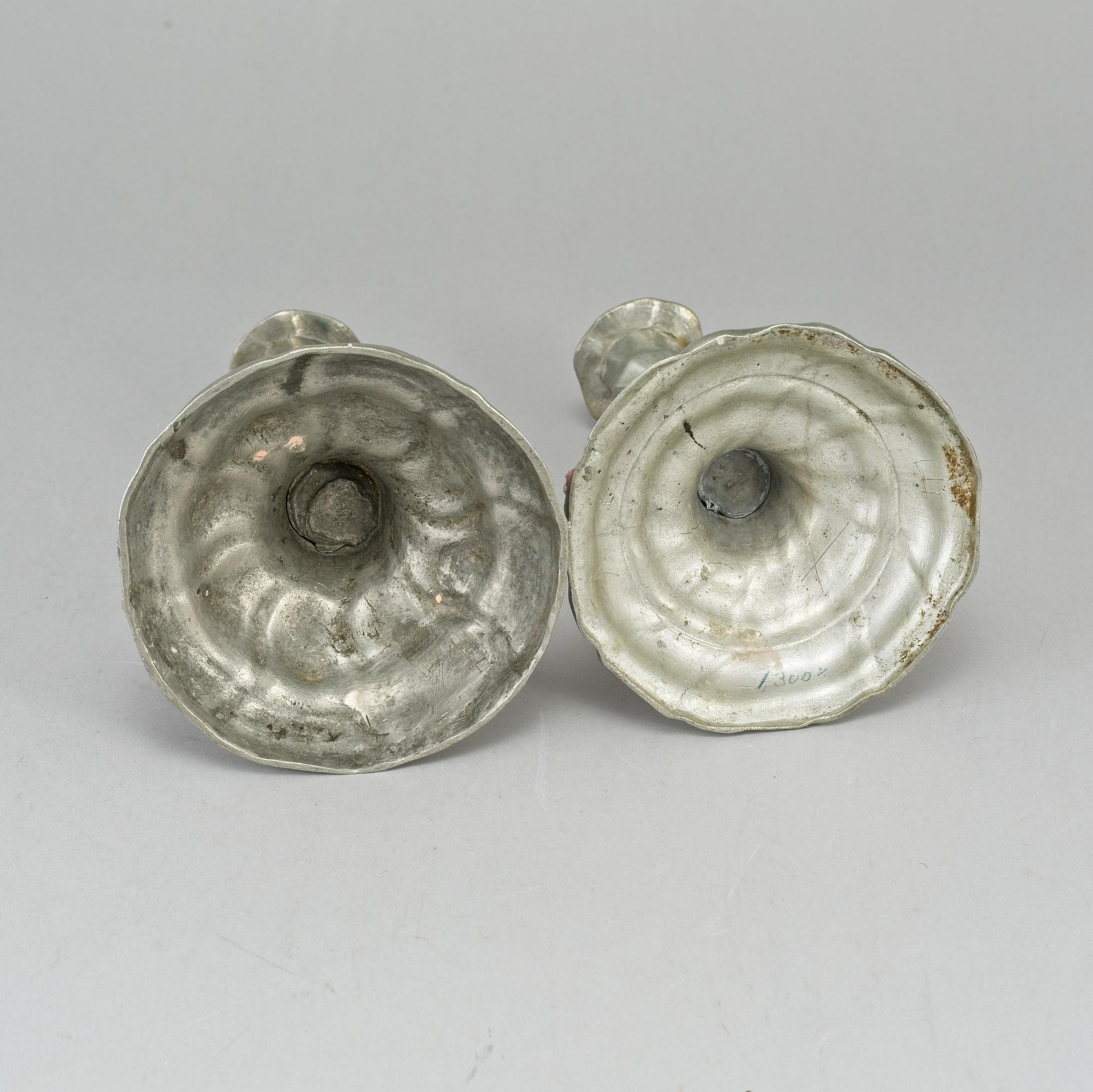 Two pewter rococo candlesticks.