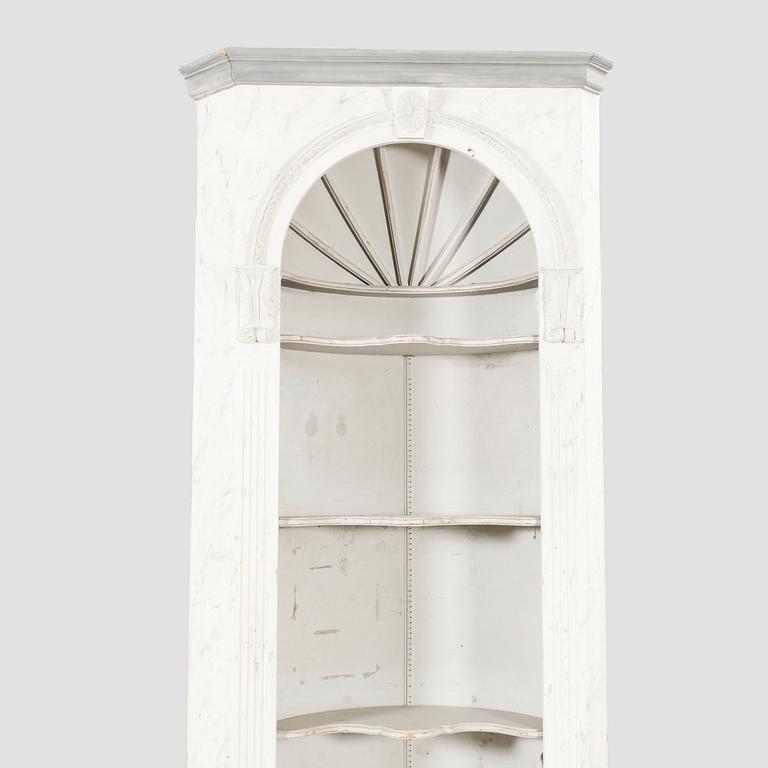 A painted Louis XVI style wallmounted corner cabinet.