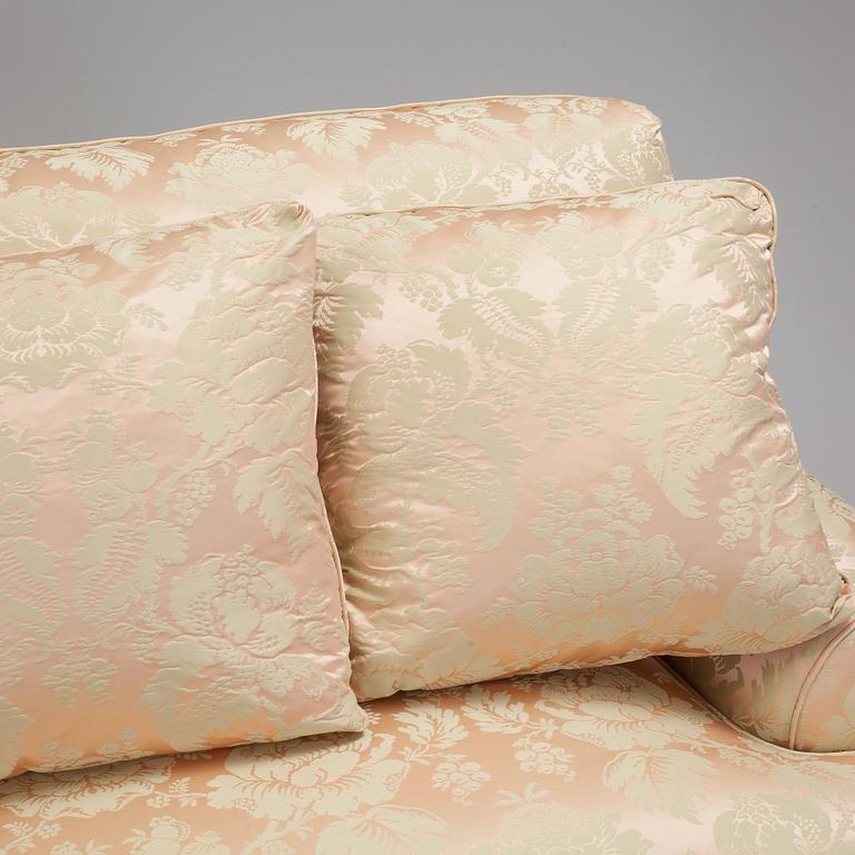 A sofa upholstered with silk damask.