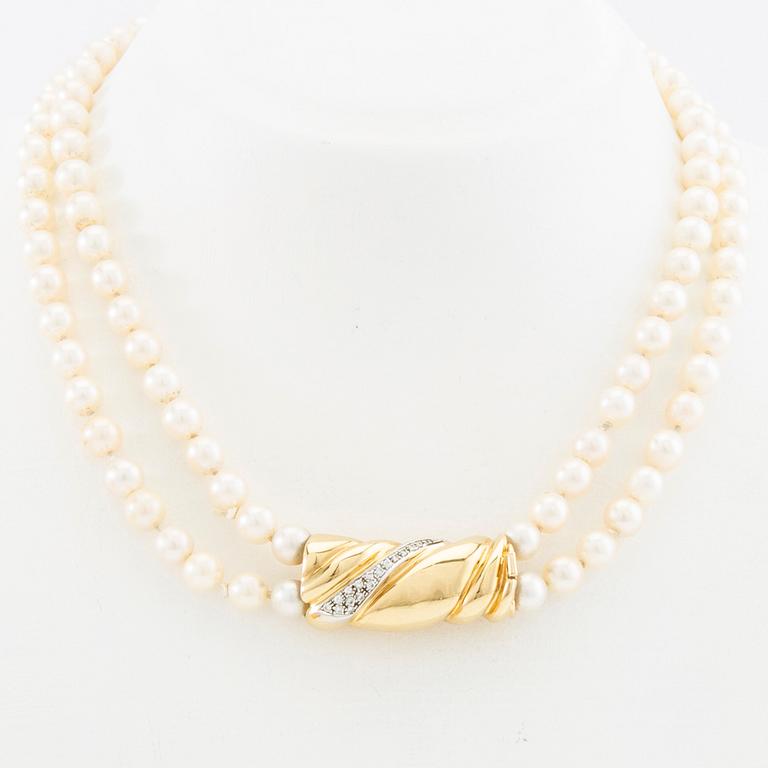 Necklace, two-stranded of cultured pearls with a clasp of 18K gold set with brilliant-cut diamonds, Damini Asolo Italy.