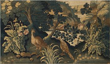 A FRAGMENT O A TAPESTRY. Tapestry weave. Verdure. Around 97 x 166 cm . Flanders,  the fist half of the 18th century.