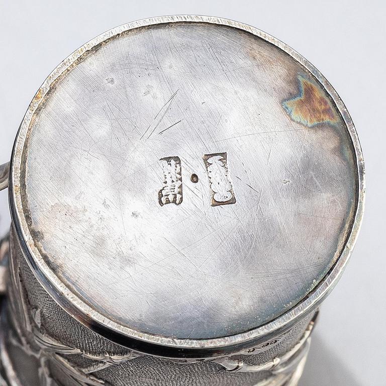 A Chinese Export silver beaker and two silver mustard pots, early 20th century.