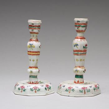 A pair of famille rose candle sticks, Qing dynasty, Qianlong (1736-95).