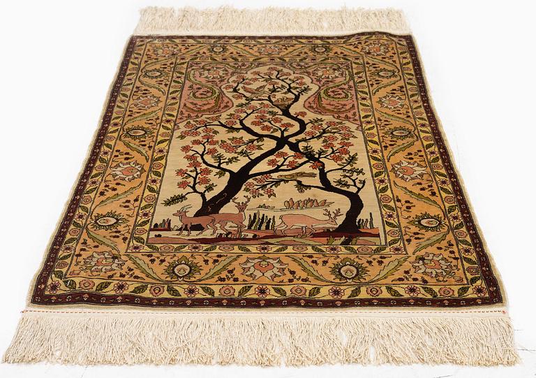 A semi-antique / old silk Hereke rug, West Anatolia, c. 100 x 60 cm.