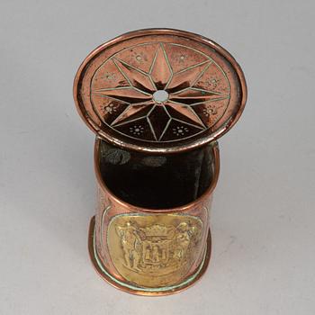 A 19th century brass and copper spoon holder.