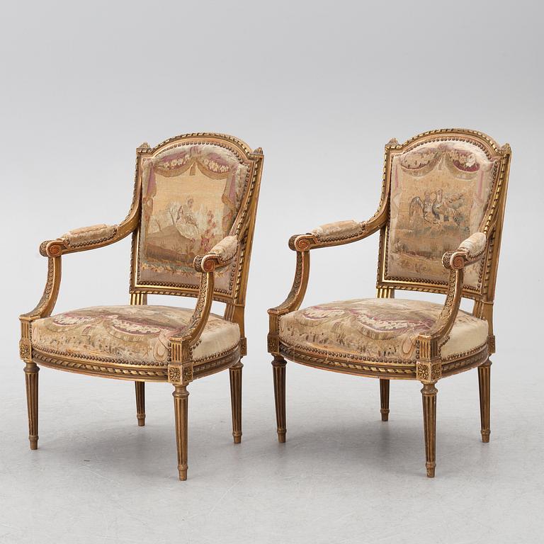 A pair of Louis XVI-style armchairs, late 19th century with 18th century fabric.