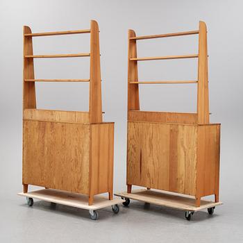 A pair of pine cupboards with shelves by Carl Malmsten.