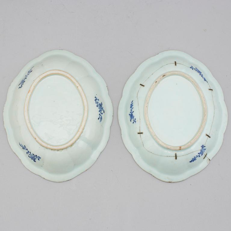 Two blue and white export porcelain tureens with covers and three dishes, Qing dynasty, 18th century.