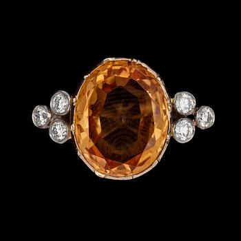1040. A 6.48 cts topaz and diamond ring. Total carat weight of diamonds 0.32 ct.