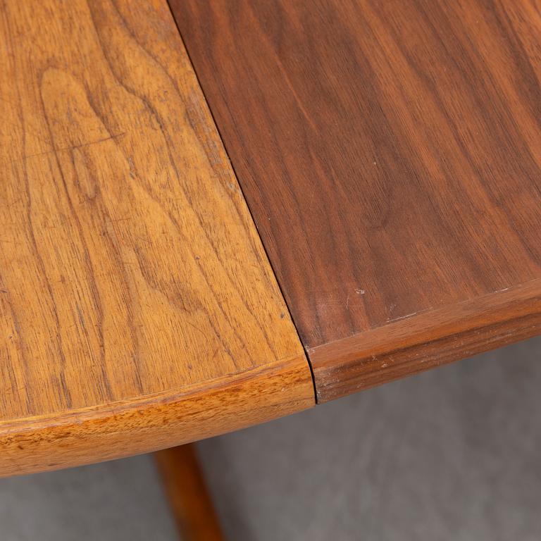 A walnut vereered dining table, mid 20th Century.