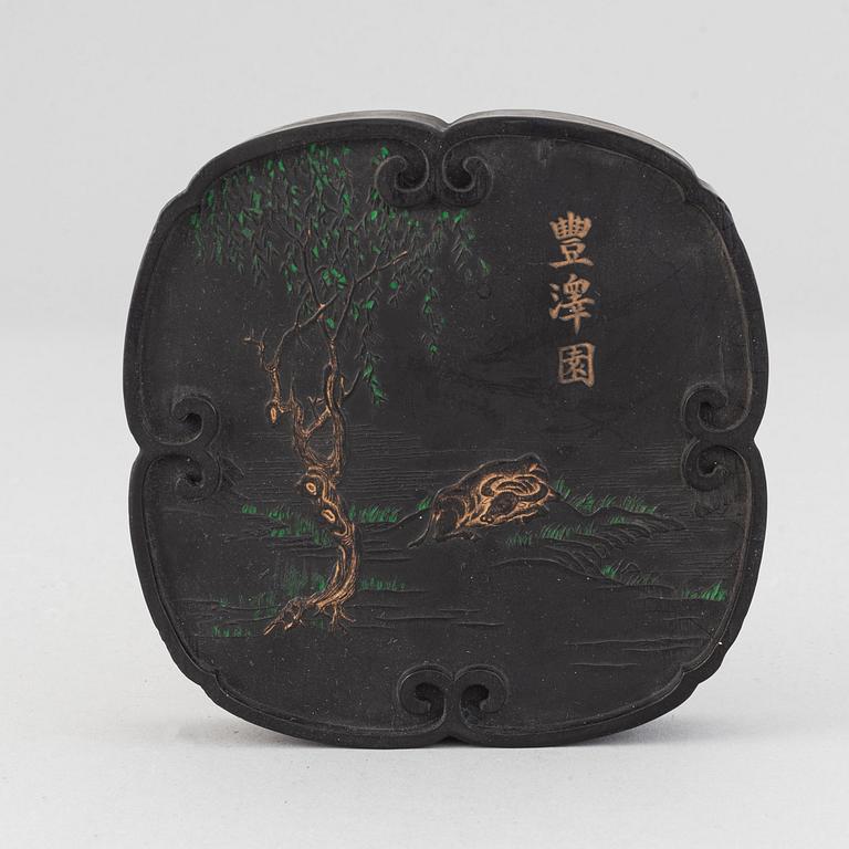 A Chinese ink-cake, with calligraphy and decorated with an ox, 20th Century.