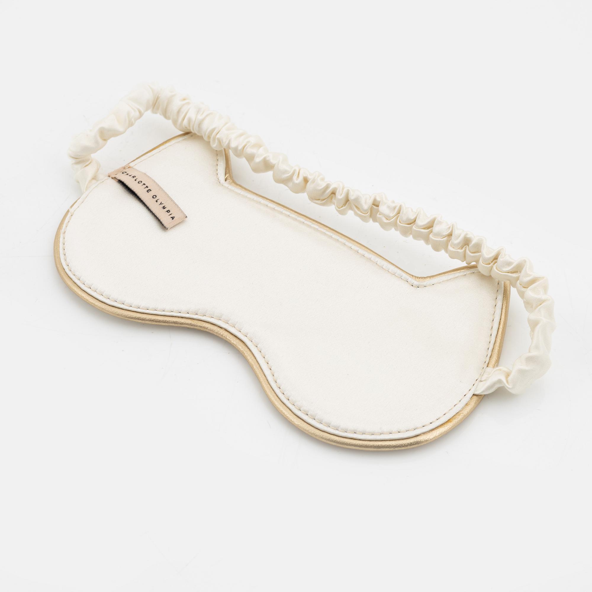 Charlotte Olympia, a pair of 'Cat nap' silk flats, a sleeping mask and a toilet bag, size S.