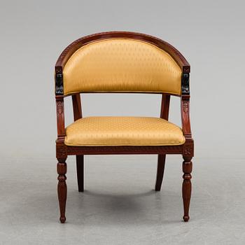 an empire-style armchair from the late 20th century.
