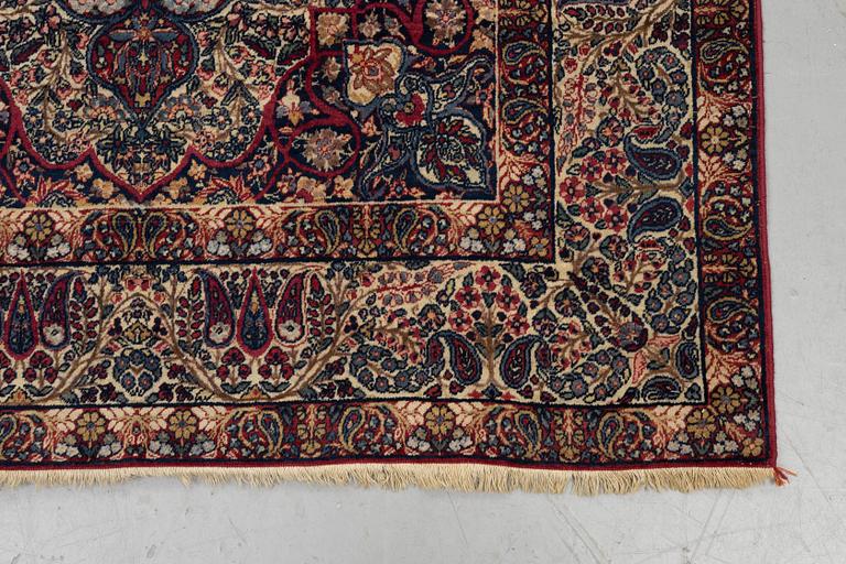 A carpet, semi-antique Kerman Laver, ca 242 x 142 cm.