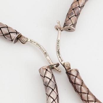BOTTEGA VENETA, a pair of silver earrings and a silver ring.