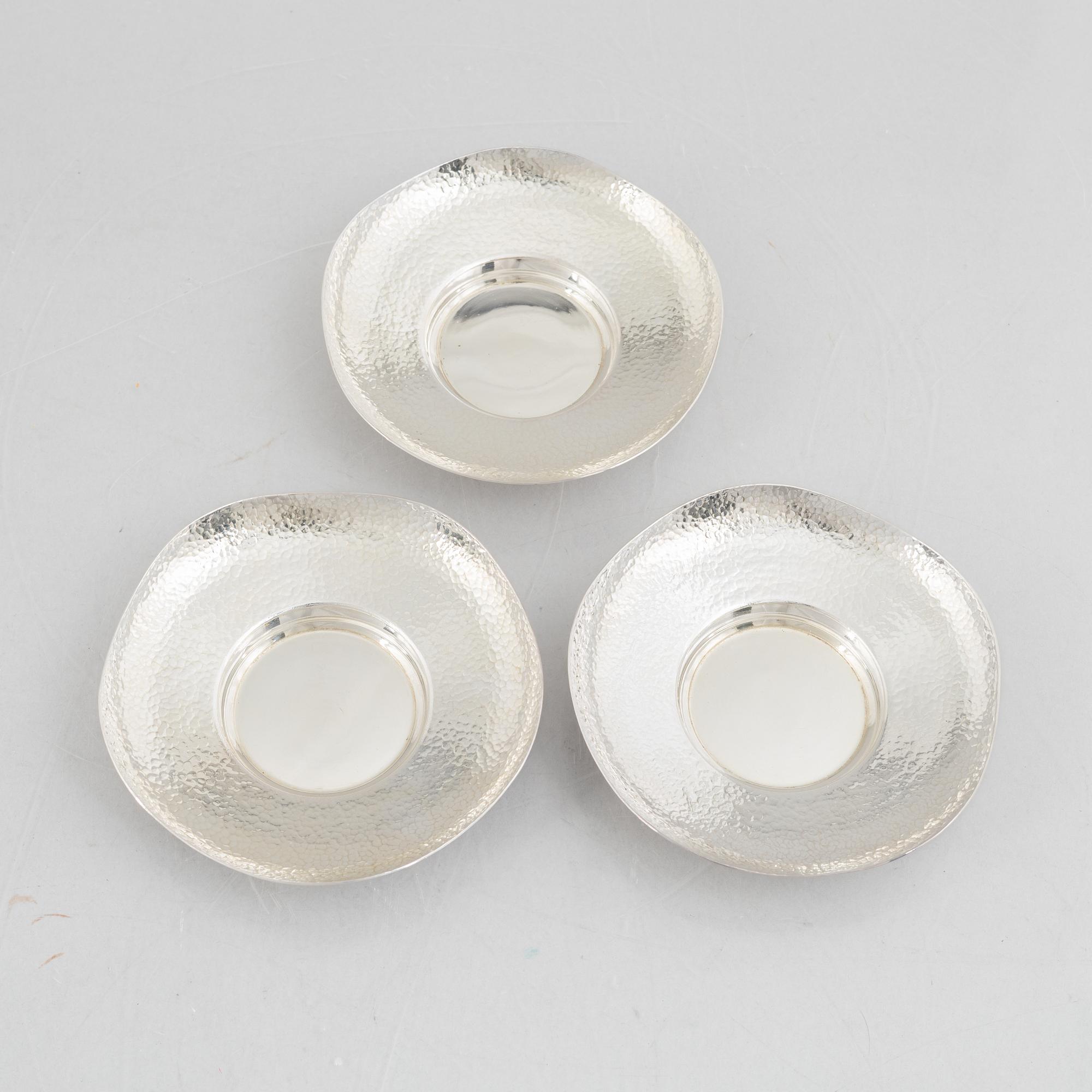 A set of three Japanese silver coasters and a pair of salts with shakers, 20th century.