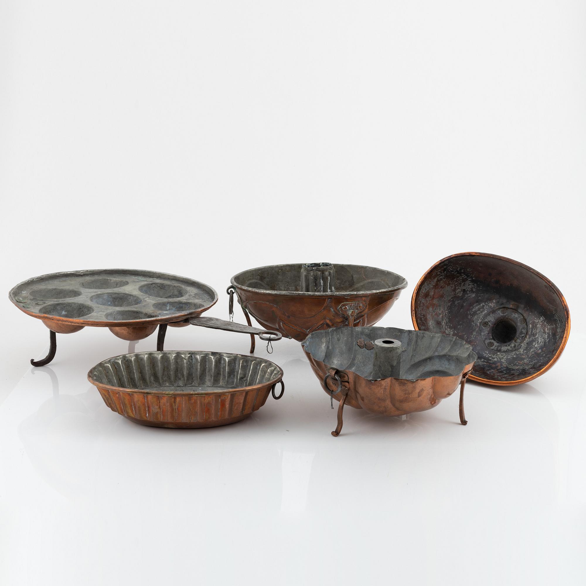 Four cake moulds, and a funnel, copper, 18th and 19th Century.