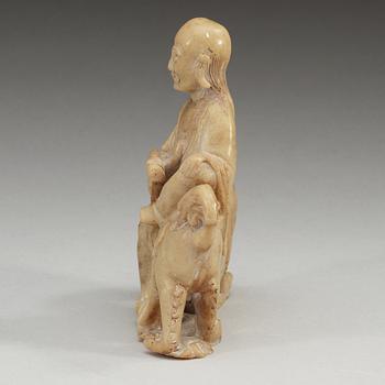 A carved stone figure, late Qing dynasty (1644-1912).