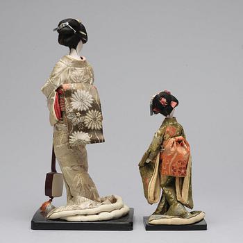 Two Japanese dolls and a box with minitures, 20th Century.